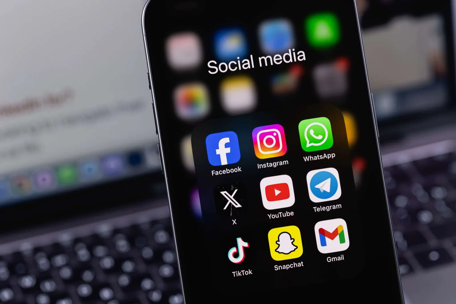 A phone showing social media apps used for B2B lead generation