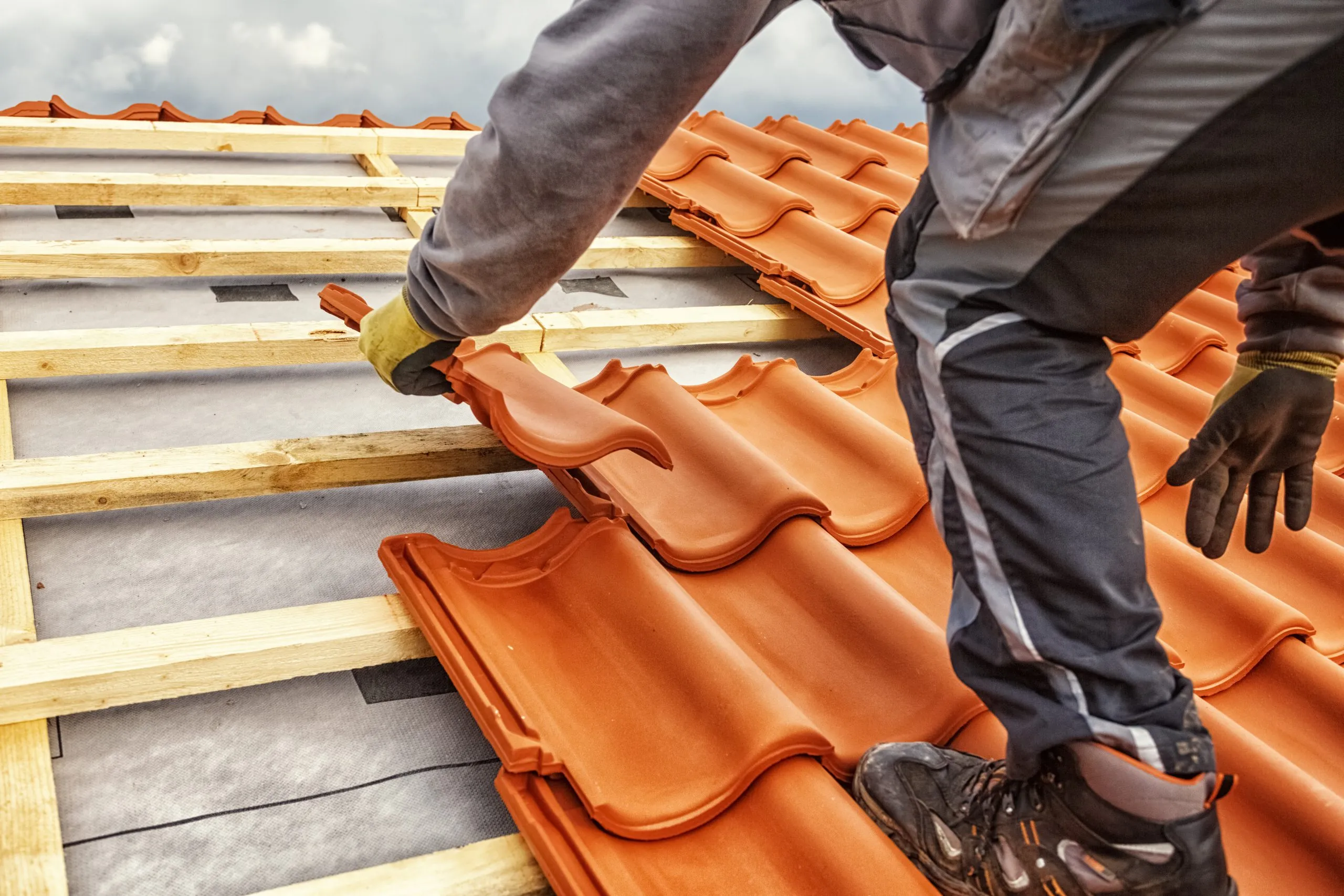 A roofer working on a residential roof