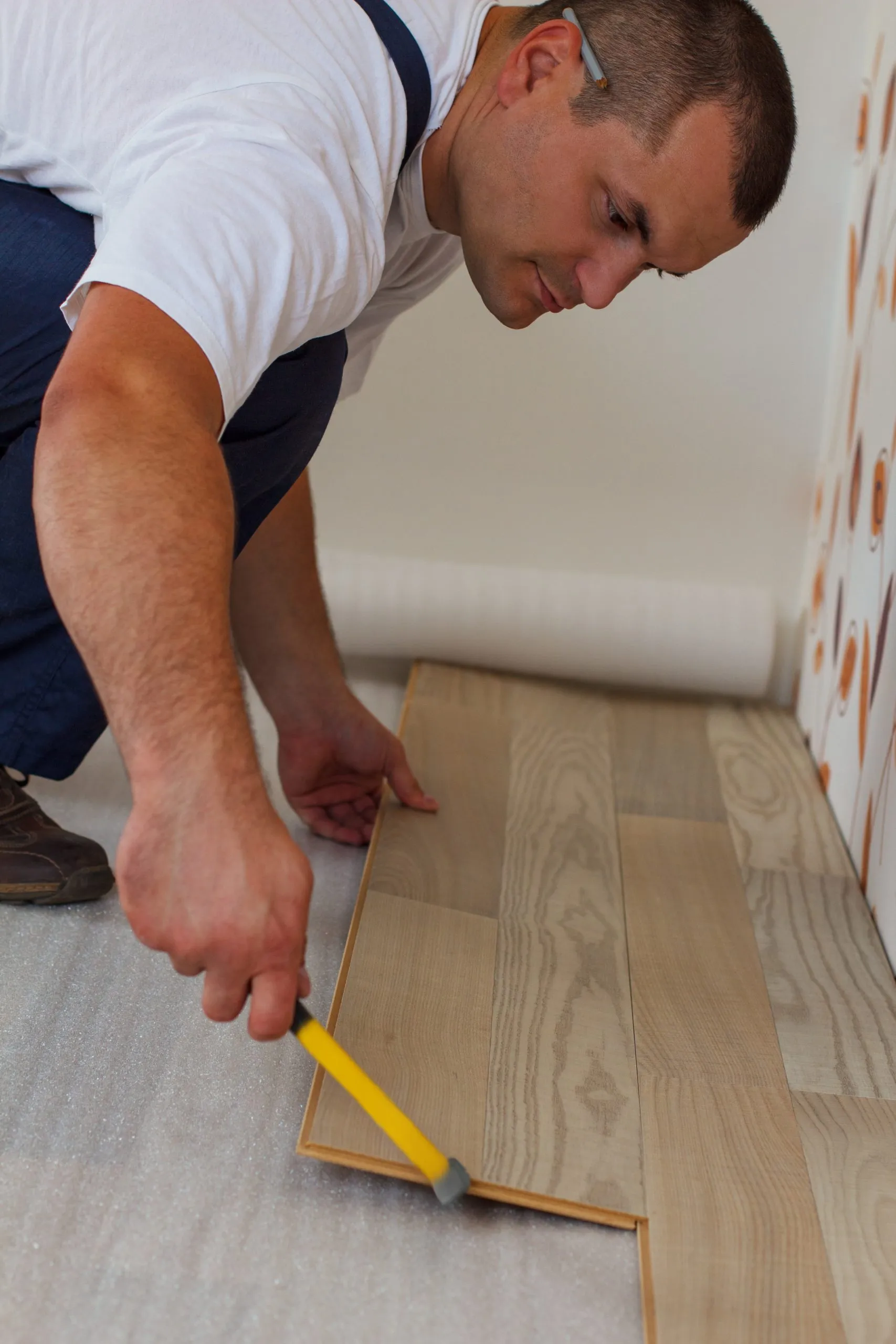 A flooring installer fitting new flooring